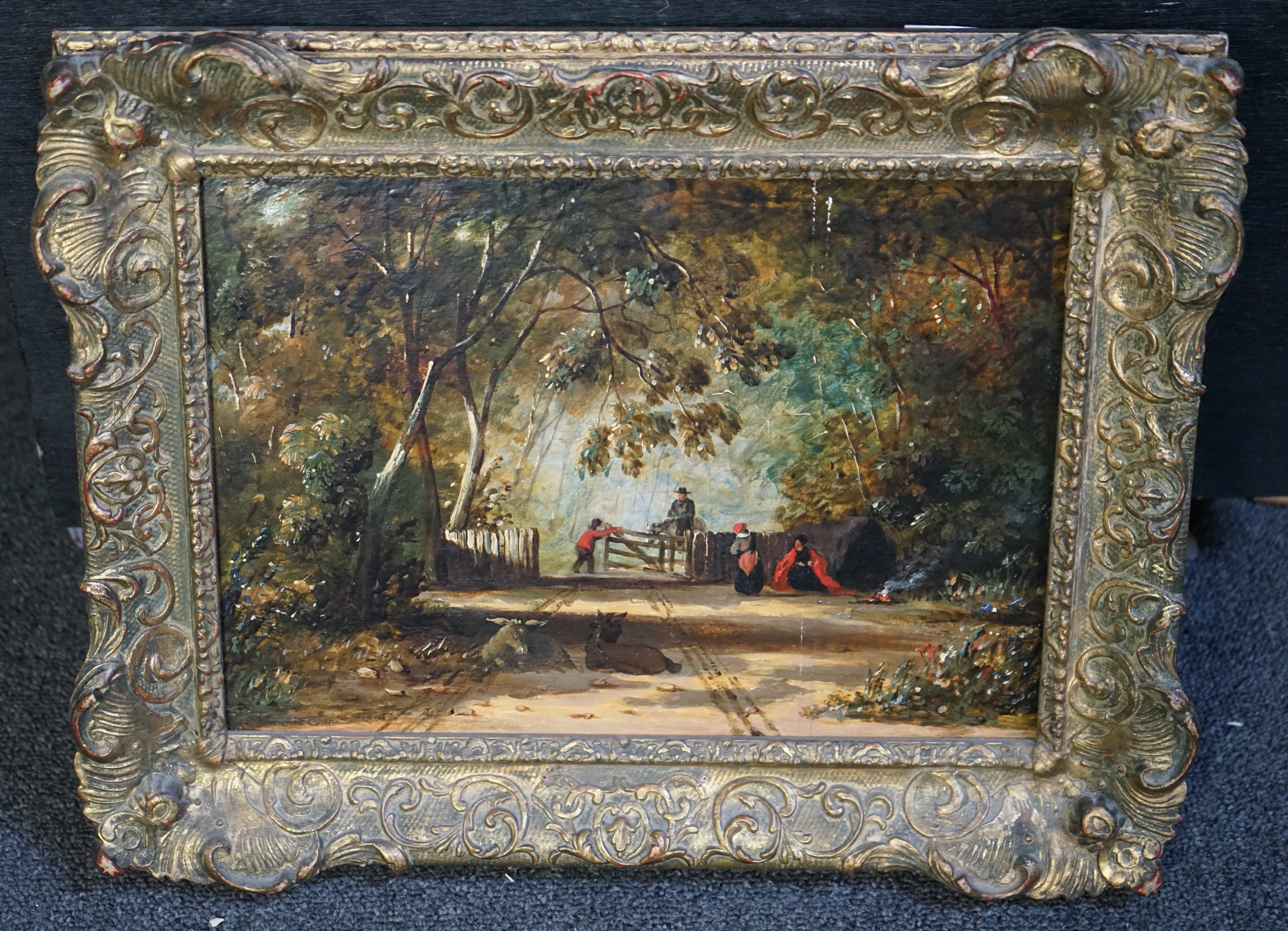 Attributed to John Linnell (English, 1792-1882), oil on oak panel, Wooded clearing with travellers and donkeys, 21 x 30cm. Condition - good